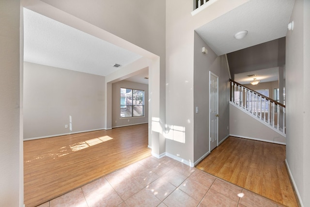 tiled entrance foyer with a textured ceiling