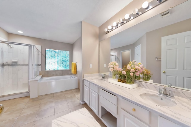 bathroom with vanity, tile patterned floors, and shower with separate bathtub