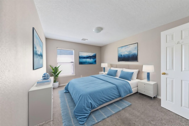 carpeted bedroom featuring a textured ceiling