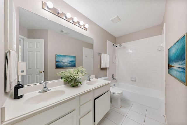 full bathroom with tile patterned floors, toilet, a textured ceiling, vanity, and tiled shower / bath combo