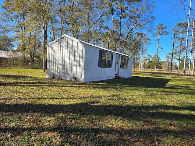 view of outbuilding featuring a yard