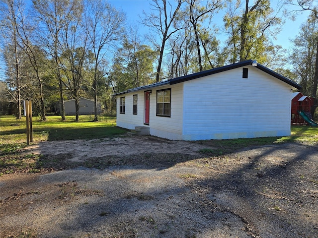 view of side of home featuring a yard