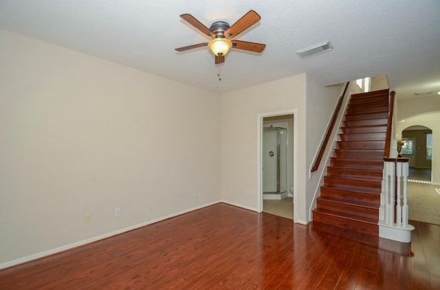 spare room featuring ceiling fan and dark wood-type flooring