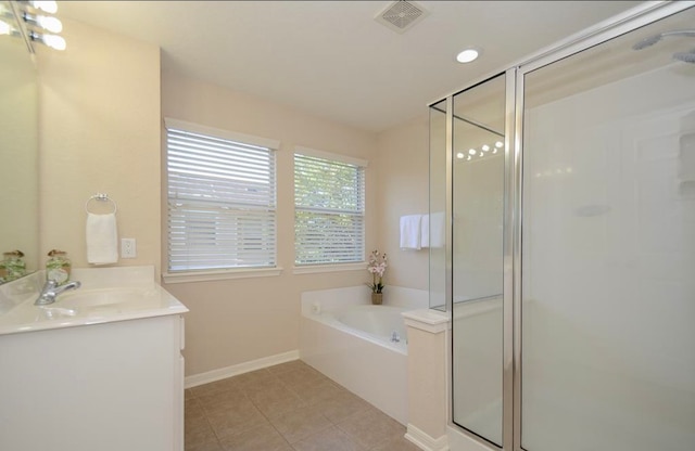 bathroom featuring tile patterned floors, vanity, and shower with separate bathtub