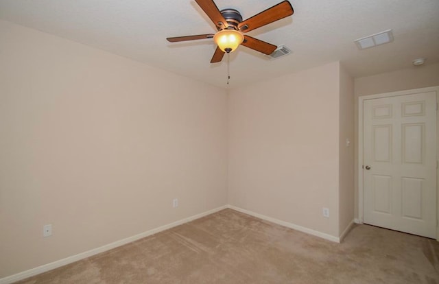 carpeted spare room with ceiling fan