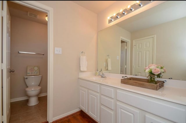 bathroom with tile patterned floors, vanity, and toilet