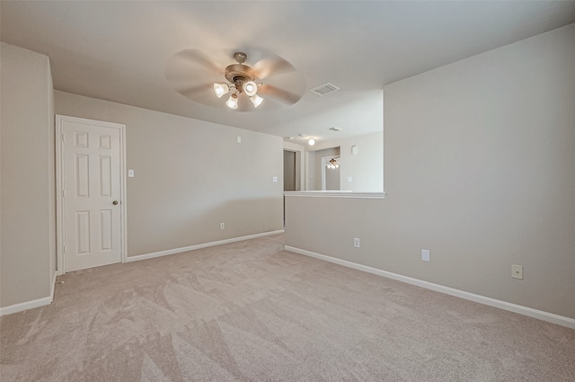 empty room featuring ceiling fan and light colored carpet