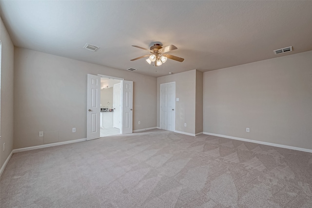 carpeted spare room with ceiling fan