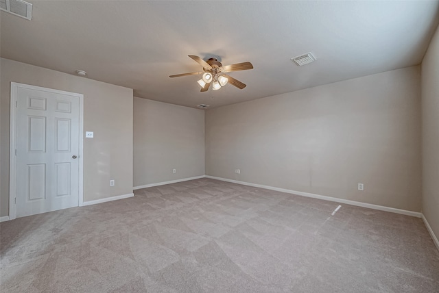 empty room with ceiling fan and light colored carpet