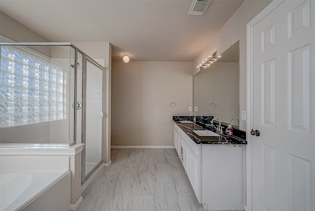 bathroom featuring vanity and independent shower and bath