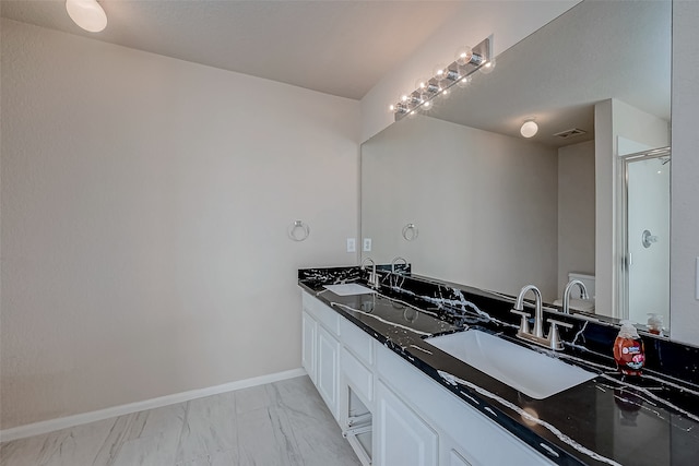 bathroom featuring vanity and a shower with shower door