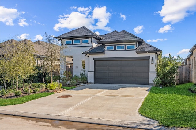 view of front facade featuring a garage and a front lawn