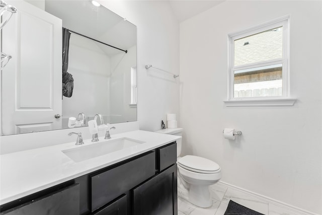 bathroom with a shower, vanity, and toilet