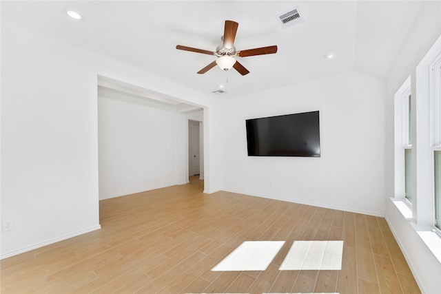 unfurnished living room with ceiling fan, lofted ceiling, and light hardwood / wood-style flooring