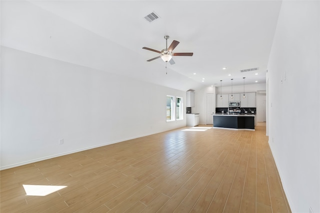 unfurnished living room featuring ceiling fan, light hardwood / wood-style floors, and lofted ceiling