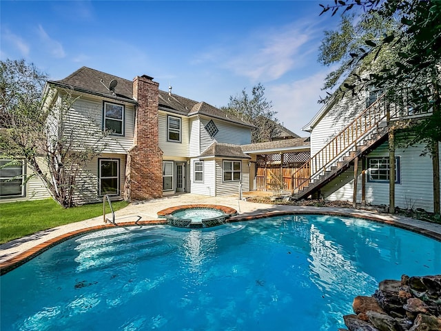 1519 Hannington Dr, Katy, TX 77450 - view of swimming pool featuring a pool with connected hot tub, stairs, and a patio