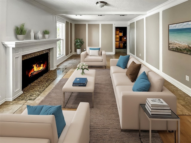 living room featuring crown molding, a high end fireplace, and a textured ceiling