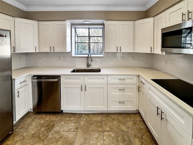 kitchen with sink, decorative backsplash, ornamental molding, white cabinetry, and stainless steel appliances