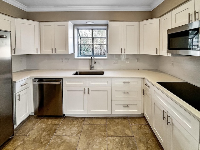 1519 Hannington Dr, Katy, TX 77450 - kitchen featuring appliances with stainless steel finishes, a sink, crown molding, white cabinetry, and light countertops