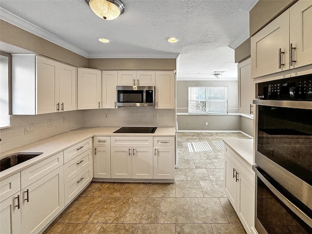 1519 Hannington Dr, Katy, TX 77450 - kitchen with stainless steel appliances, a sink, backsplash, white cabinets, and ornamental molding