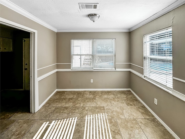 empty room featuring ornamental molding and a textured ceiling