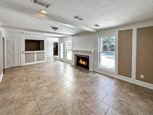 1519 Hannington Dr, Katy, TX 77450 - unfurnished living room with a textured ceiling, plenty of natural light, a fireplace, and baseboards