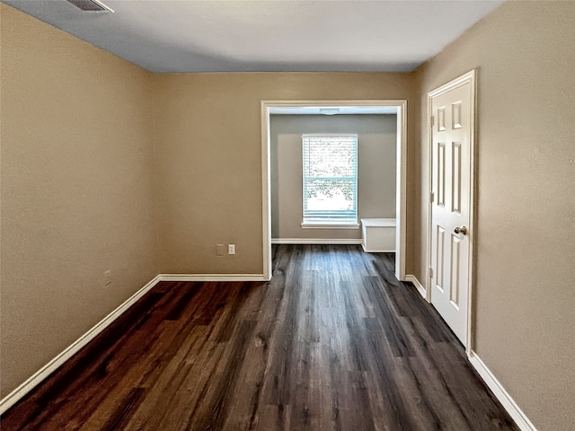 spare room with dark hardwood / wood-style flooring