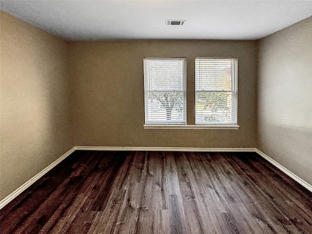 empty room featuring dark wood-type flooring