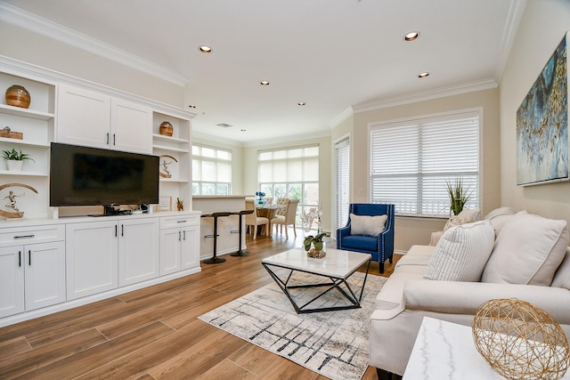 living room featuring light wood-type flooring and crown molding