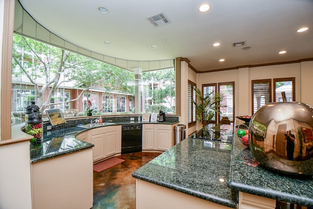 kitchen with white cabinets, dark stone countertops, crown molding, and sink