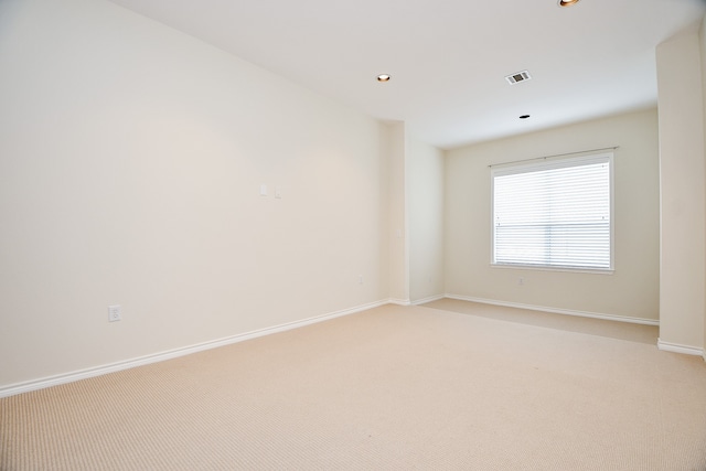 unfurnished room featuring light colored carpet