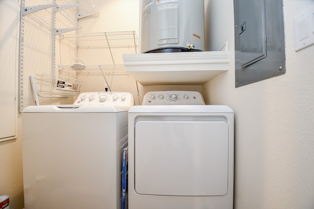 laundry room with independent washer and dryer, electric panel, and water heater