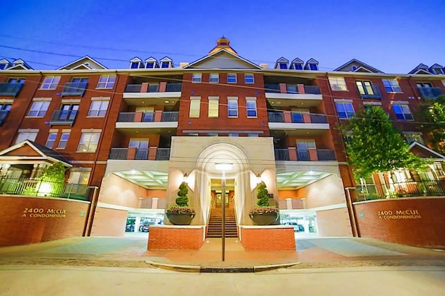 view of outdoor building at dusk