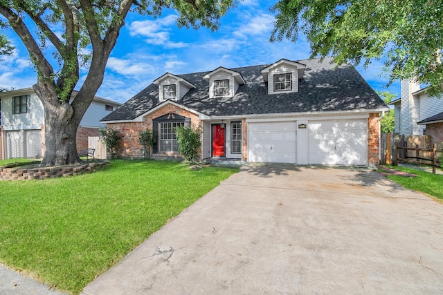 cape cod home with a garage and a front lawn