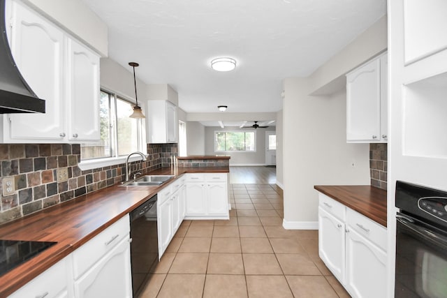 kitchen featuring pendant lighting, black appliances, sink, ceiling fan, and butcher block countertops