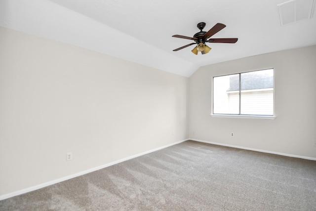 unfurnished room featuring carpet flooring, vaulted ceiling, and ceiling fan