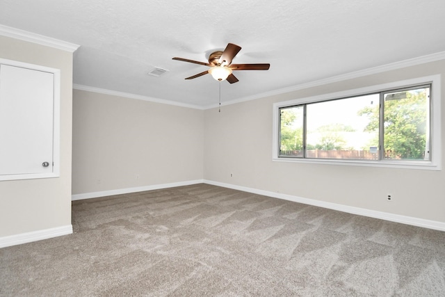 spare room featuring crown molding, carpet, and ceiling fan