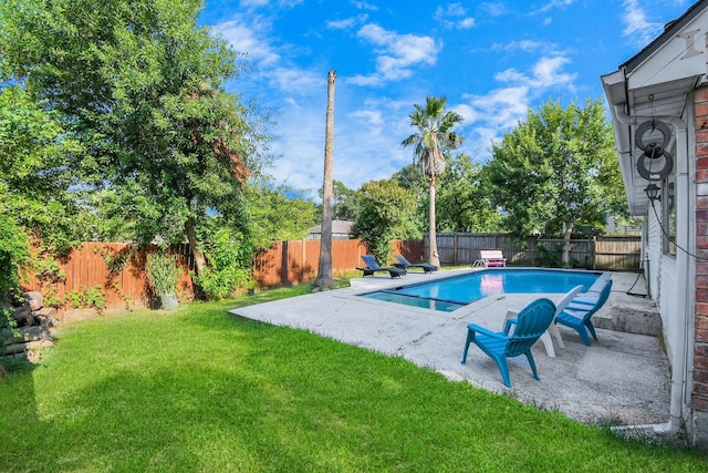 view of pool featuring a patio area and a lawn