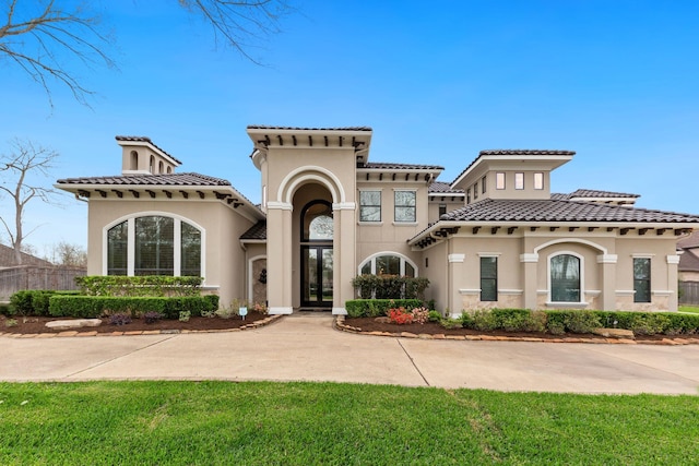 mediterranean / spanish-style home with a front lawn