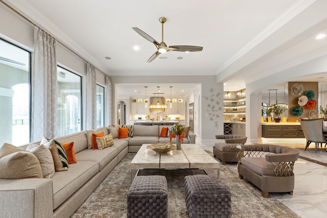 living room featuring ceiling fan and ornamental molding