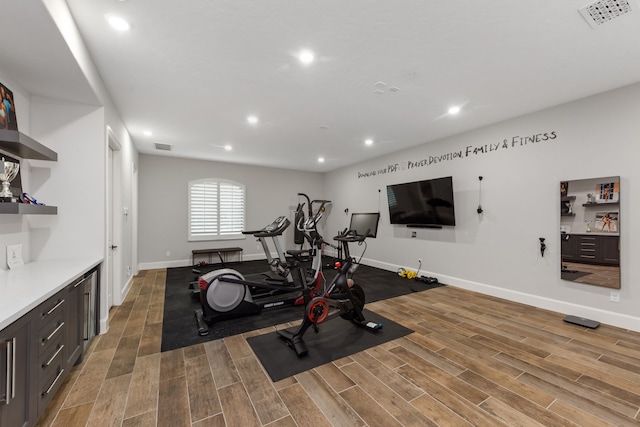 workout area with hardwood / wood-style floors