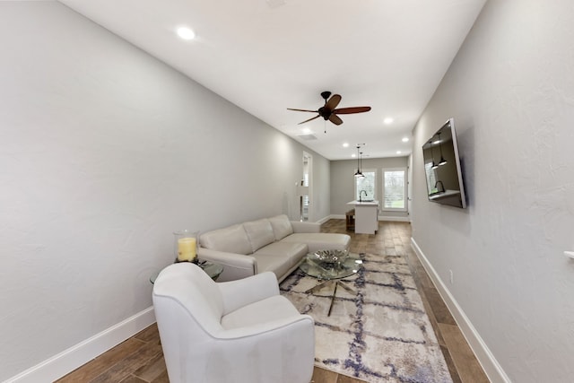 living room with dark hardwood / wood-style floors and ceiling fan