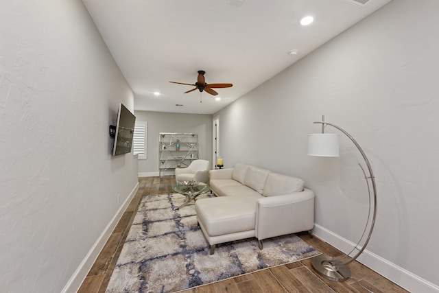 living room with wood-type flooring and ceiling fan