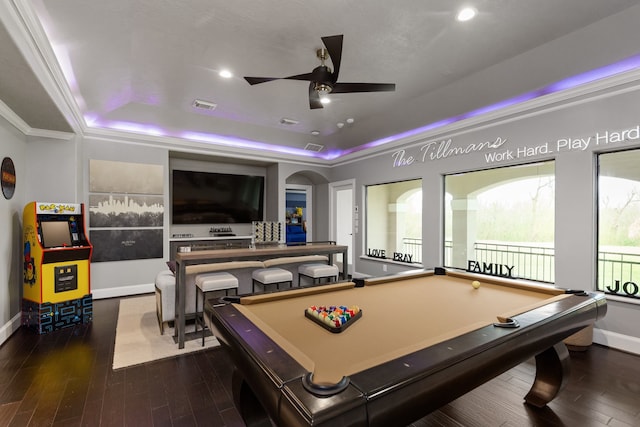 recreation room with a tray ceiling, crown molding, dark wood-type flooring, and pool table