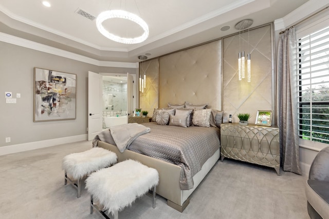 carpeted bedroom with a tray ceiling, ensuite bathroom, and ornamental molding