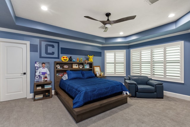 bedroom with carpet flooring, a raised ceiling, ceiling fan, and crown molding