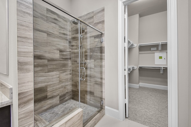 bathroom with tile patterned flooring and walk in shower