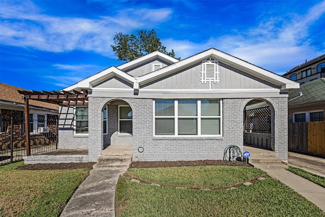 view of front of property featuring a pergola and a front lawn