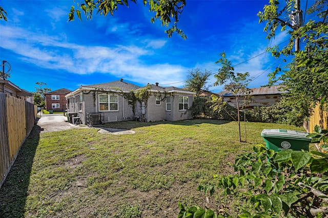 rear view of property with a yard