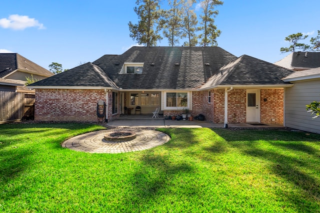 back of house featuring a yard, a patio, and an outdoor fire pit